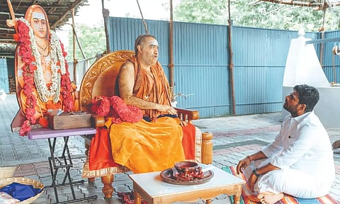 BJP state president K Annamalai listening to Kanchi Shankaracharya Sri Vijayendra Saraswathi Swamigal in Orikkai, Kancheepuram on Wednesday