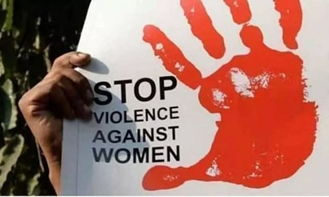 A placard denouncing violence against women being held at a protest march. (File Photo | PTI)