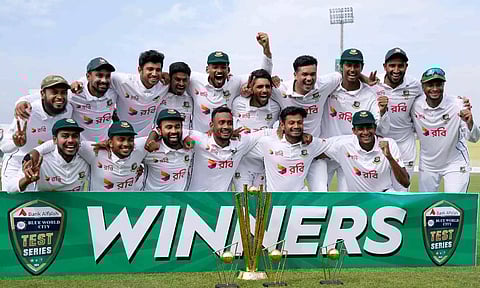 The victorious Bangladesh team poses with the trophy