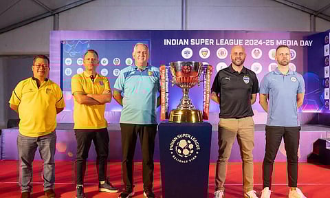 Managers of different ISL clubs pose with the trophy during media day in Kochi