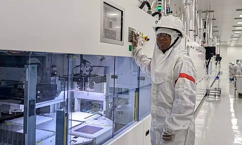 A woman working at the stat-of-the-art cell production line at Tata Power's Solar Cell unit