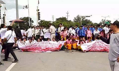 Students take part in a protest march against the recent violence in Manipur