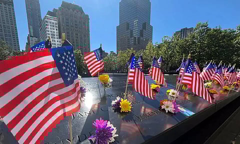 Flags and flowers are placed by the names of those killed during the September 11, 2001 attacks