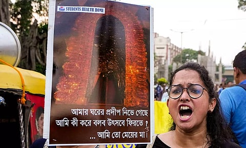 Doctors display placards during a protest dharna over the RG Kar Hospital rape and murder incident, in Kolkata (PTI)