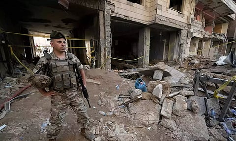 A Lebanese soldier secures the area at the site of Friday's Israeli strike in Beirut's southern suburbs, Saturday (Photo: AP)