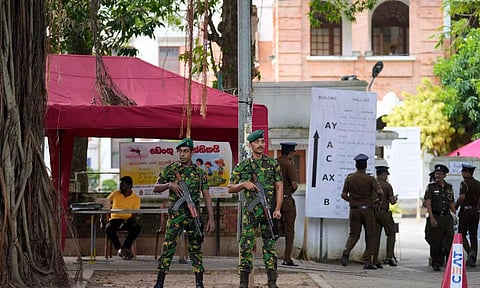 Police commandos stand guard outside a ballot counting center in Colombo (PTI)
