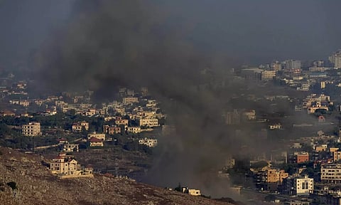 Smoke rises from an Israeli air strike (AP)