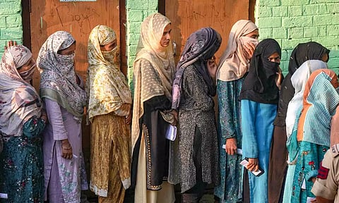 Voters stand in a queue at a polling station to cast votes during the second phase of Jammu and Kashmir Assembly elections, in Srinagar district (PTI)