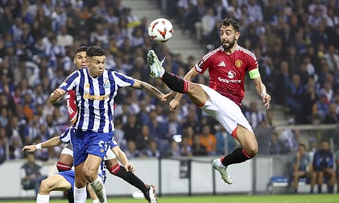  Manchester United's Bruno Fernandes reaches for the ball too high and close to the head of Porto's Nehuen Perez to see a second yellow card