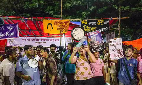 Junior doctors stage a protest against the alleged rape and murder of their colleague at the RG Kar hospital at their sit-in site, in Kolkata (PTI)