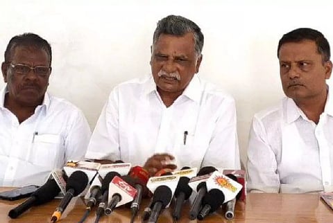 Mutharasan talking to reporters