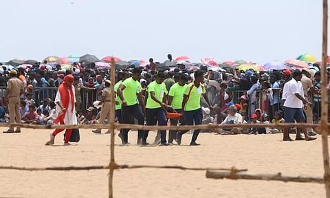 volunteers carry spectators who took ill at Marina beach on Oct 6, 2024. (Photos | Manivasagan)