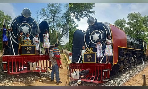 Kids enjoy their rare chance to stand on a steam loco engine at the Golden Rock Railway Workshop in Tiruchy on Thursday