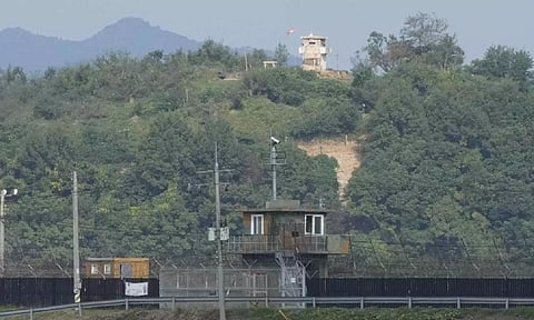 A North Korean military guard post, top, and a South Korean post, seen from Paju, South Korea (AP)
