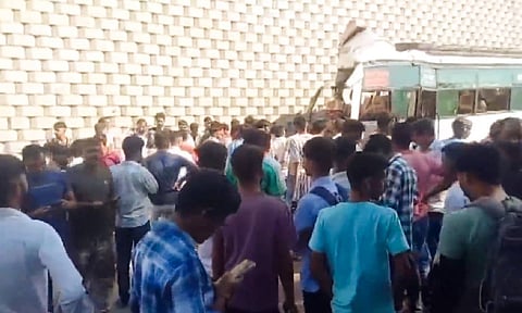 People gather near the mangled remains of a bus after it crashed into the wing wall of a flyover, leaving at least ten people dead and 36 injured, in Rajasthan's Sikar district, Tuesday, Oct. 29, 2024. 