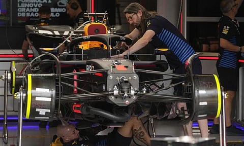 Crew members working on the car (AP)