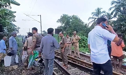  Police personnel investigate following the death of four sanitary workers after being hit by the Kerala Express train (PTI)