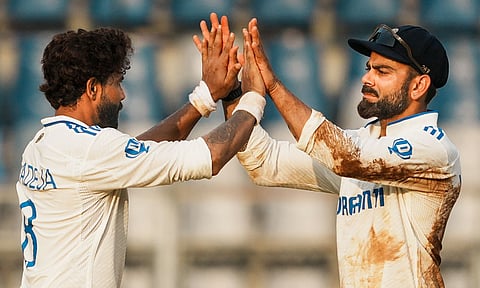 India's Ravindra Jadeja celebrates with Virat Kohli after taking the wicket of New Zealand's Matt Henry on the second day of the third test cricket match (PTI) 