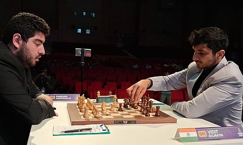 Vidit Gujrathi makes a move on the board against Parham Maghsoodloo