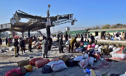Security officials examine the site of a bomb explosion at railway station in Quetta