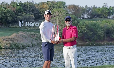 Keita Nakajima of Japan (left) with the Hero Indian Open 2024 trophy and chairman of Hero MotoCorp Pawan Munjal