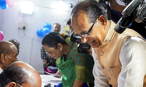 Union Minister Shivraj Singh Chouhan gets his finger marked with indelible ink before casting his vote during Budhni Assembly constituency bypoll, in Sehore district of Madhya Pradesh, (PTI Photo) 