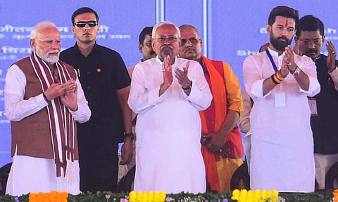 Prime Minister Narendra Modi being presented a memento during the inauguration of multiple developmental projects, in Darbhanga, Bihar, (PTI Photo)