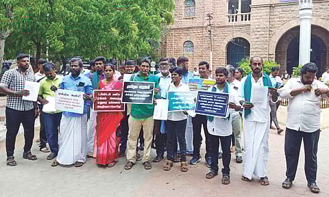 Activist Mugilan and others protesting on the premises of the Collectorate in Madurai on Monday