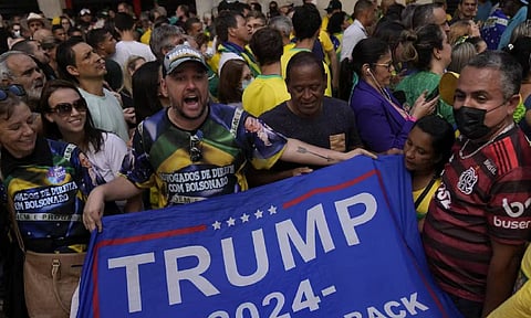 Supporters of Brazil's ex-President Jair Bolsonaro voice their support for Trump