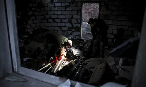 Servicemen of the 24th Mechanised Brigade prepare to fire 120mm mortar towards Russian positions near Chasiv Yar town (AP)