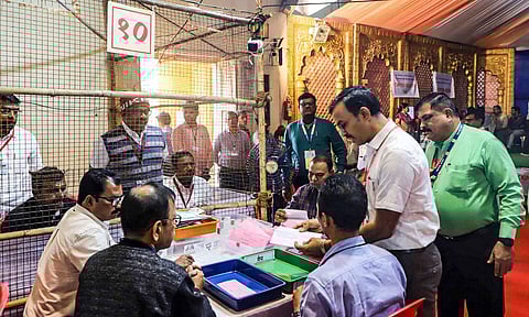 Polling officials at a counting center amid the counting of votes for the Maharashtra Assembly elections (PTI)