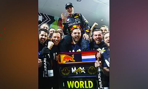 Max Verstappen celebrates with his teammates after winning fourth title
