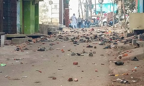 Footwears and brick bats lying on a road after violence erupted during the second survey of the Jama Masjid (PTI)
