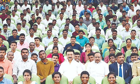 Chief Minister MK Stalin poses with new appointees selected through the Tamil Nadu Uniformed Staff Selection Board, at Kalaivanar Arangam on Wednesday