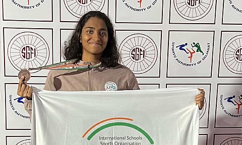 Deeksha Sivakumar poses with the medal she won 