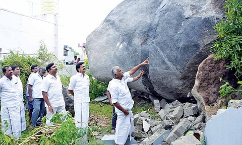 AIADMK deputy general secretary KP Munusamy inspects the boulder that rolled down and halted close to a house in Krishnagiri