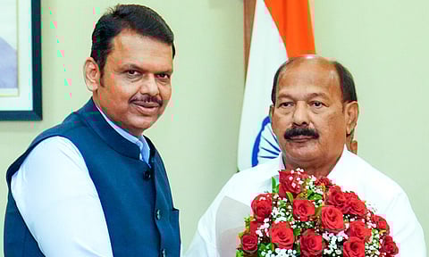 Maharashtra Chief Minister Devendra Fadnavis congratulates MLA Kalidas Kolambkar after he was elected as the pro-tem Speaker of the state Legislative Assembly, in Mumbai