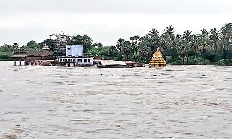A view of the swollen Thamirabarani river amid floods, in Tirunelveli district