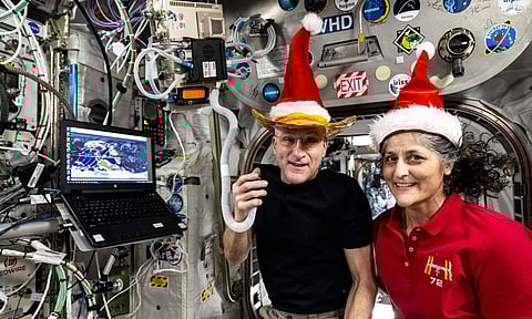 Don Pettit and Suni Williams pose for a fun holiday season portrait while speaking on a ham radio inside the International space station (X)