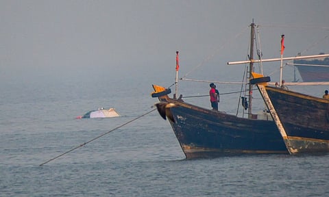 Portion of a ferry, which was recently capsized off Mumbai coast when a Navy craft crashed into it, is seen afloat at Bhaucha Dhakka