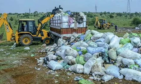 Medical and other waste from Kerala that was illegally dumped in Tirunelveli is being removed by Kerala authorities, in Tirunelveli, Tamil Nadu, on Sunday (PTI) 