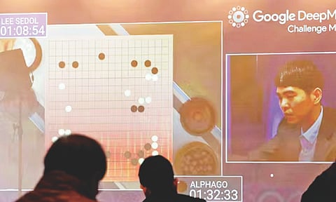 Photo showing a Go board and player and spectators. In 2016, the AlphaGo AI system defeated world Go champion Lee Sedol (Image/AP)