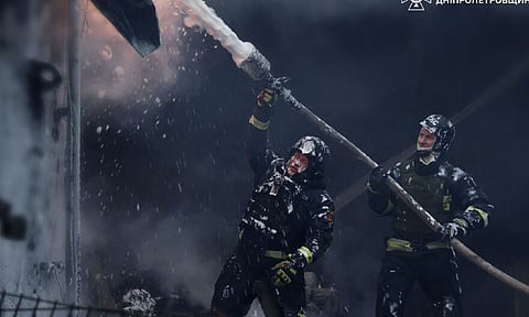 Firefighters put out a fire following a Russian missile attack on the country's energy system