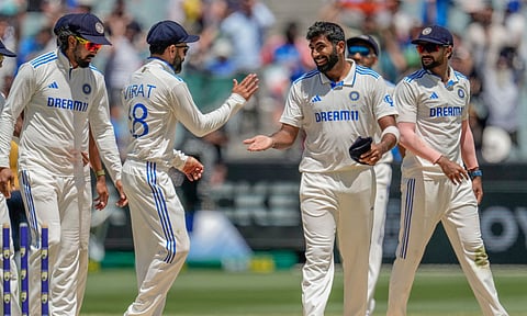 India's Jasprit Bumrah, second right without cap, celebrates with teammates after the dismissal of Australia's Alex Carey during play on the day four of the fourth cricket (PTI)