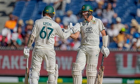Australia's Nathan Lyon, left, and Scott Boland shake hands during play on the day four of the fourth cricket test between Australia and India (PTI) 