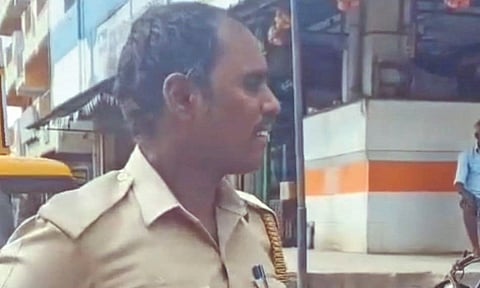 Murali in uniform arguing with real police officials