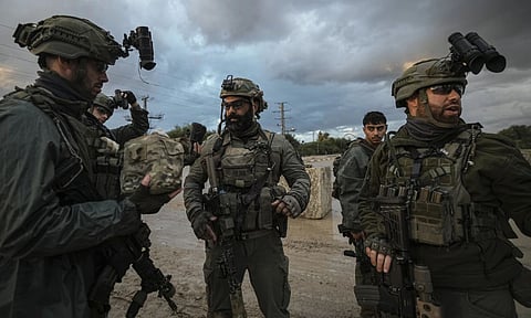 Israeli soldiers prepare to be deployed to the Gaza Strip near the Israeli-Gaza border in southern Israel (AP)