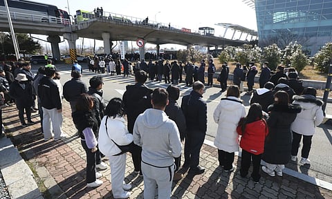 Mourners wait to pay tribute to the victims of a plane fire at a memorial altar at Muan International Airport (AP)