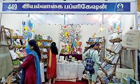 The colourful display of paintings and photos with the theme of nature attracts visitors to the stall
