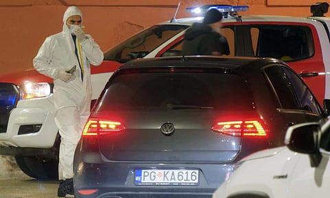 Police investigators work at the site of a shooting in Cetinje, 36 kilometers (22 miles) west of Podogrica, Montenegro (AP)